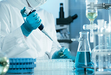 Technician pipetting in a laboratory