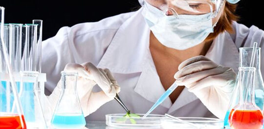 Scientist working with a pipette and culture dish
